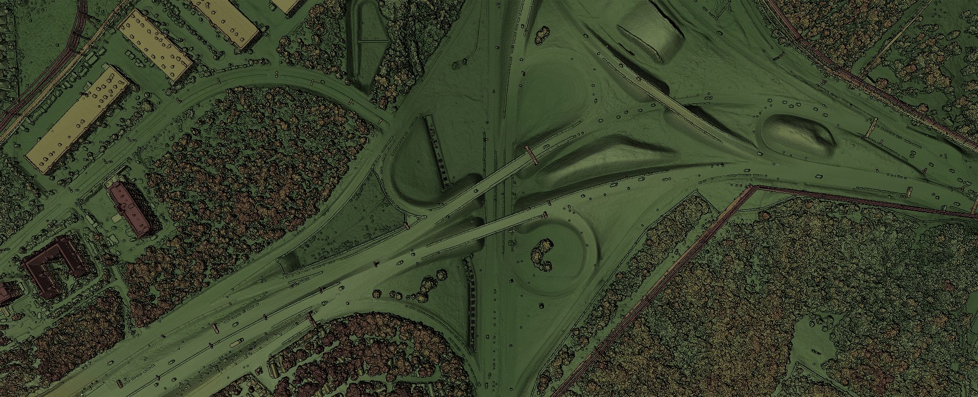 An aerial LiDAR point cloud of a highway interchange, shaded so road, ground, vegetation and buildings are visibly distinct.
